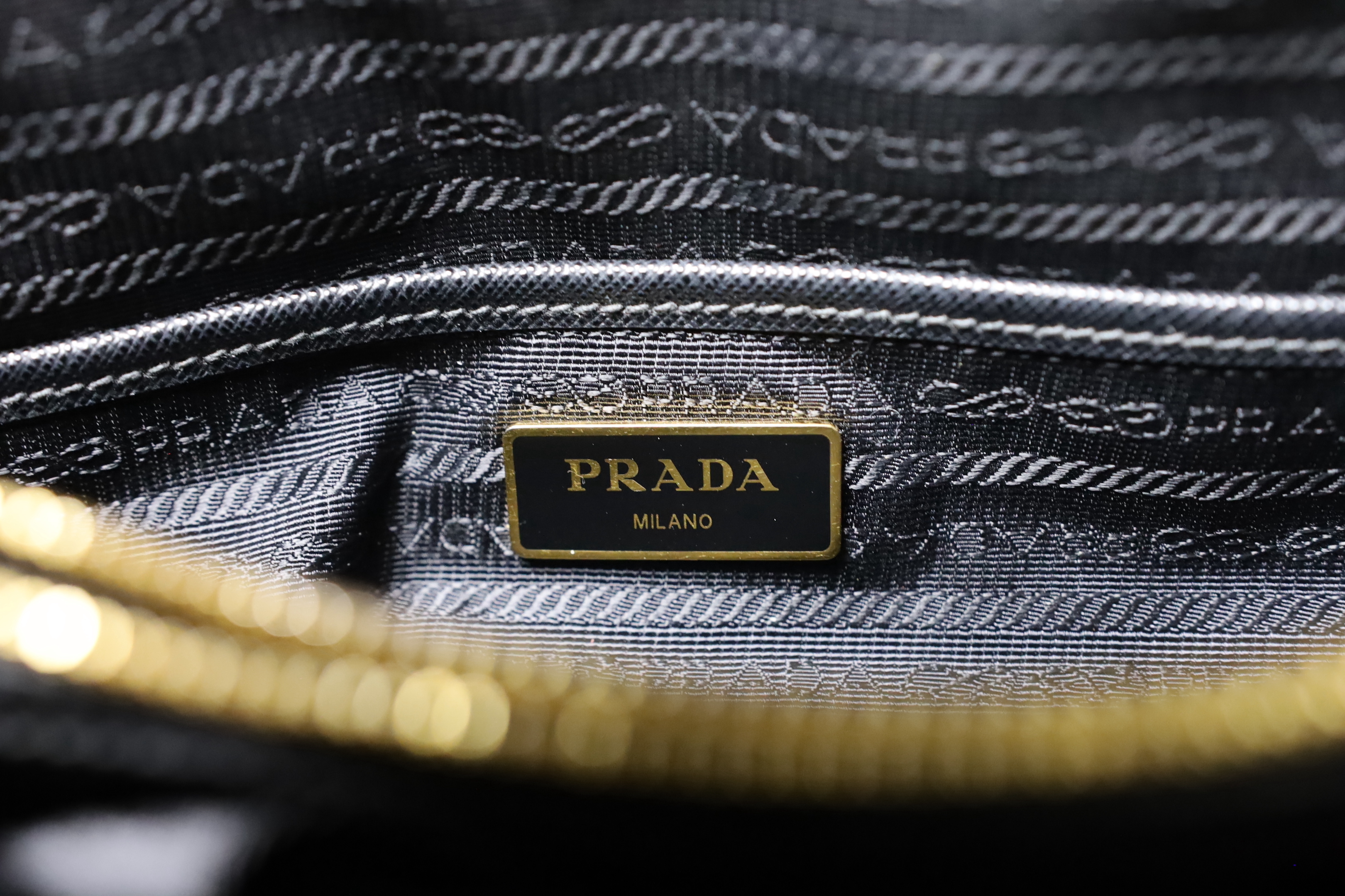 A Prada bag, with authenticity cards and dust bag